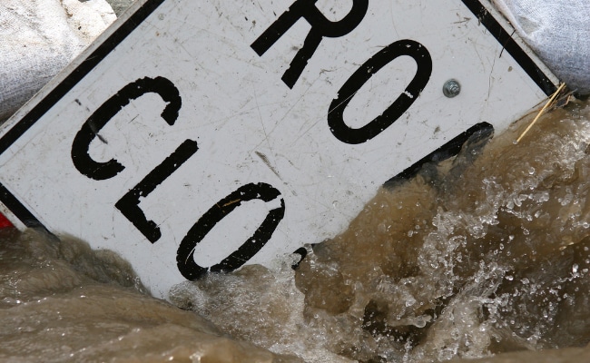 Road sign knocked down by flood waters. Researchers found flood risk higher than estimated