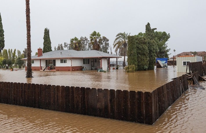 Deep flood waters surround ranch home in California
