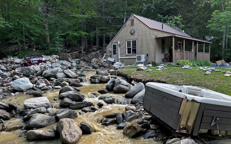 Flood waters pushed boulders down a hillside in Vermont, damaging car and hot tub.