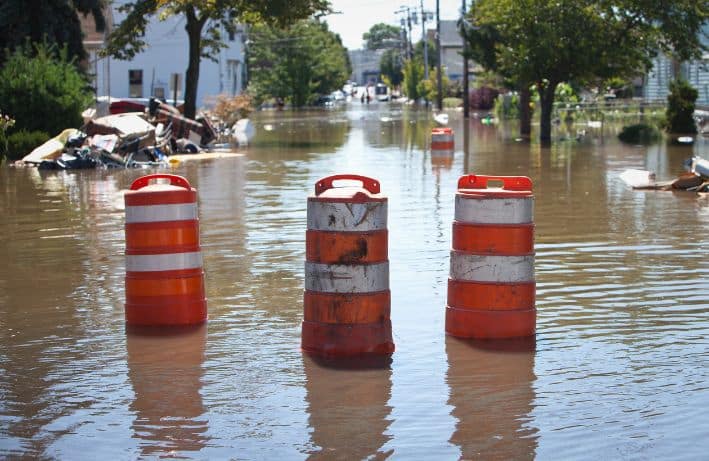 Safety barrels blocking off a flooded street